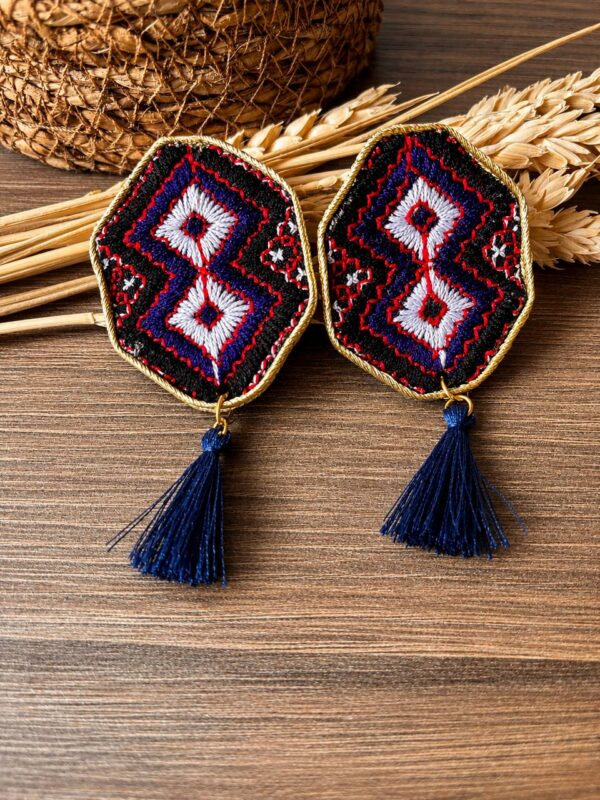 White double-diamond embroidered earrings with red details and navy tassels