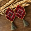 Red geometric embroidered earrings with grey-green tassels