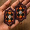 Navy embroidered earrings with orange flowers reflective diamond centres and red bead drops