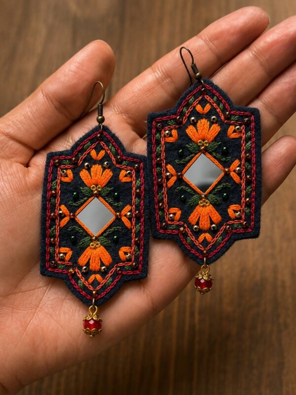 Navy embroidered earrings with orange flowers reflective diamond centres and red bead drops